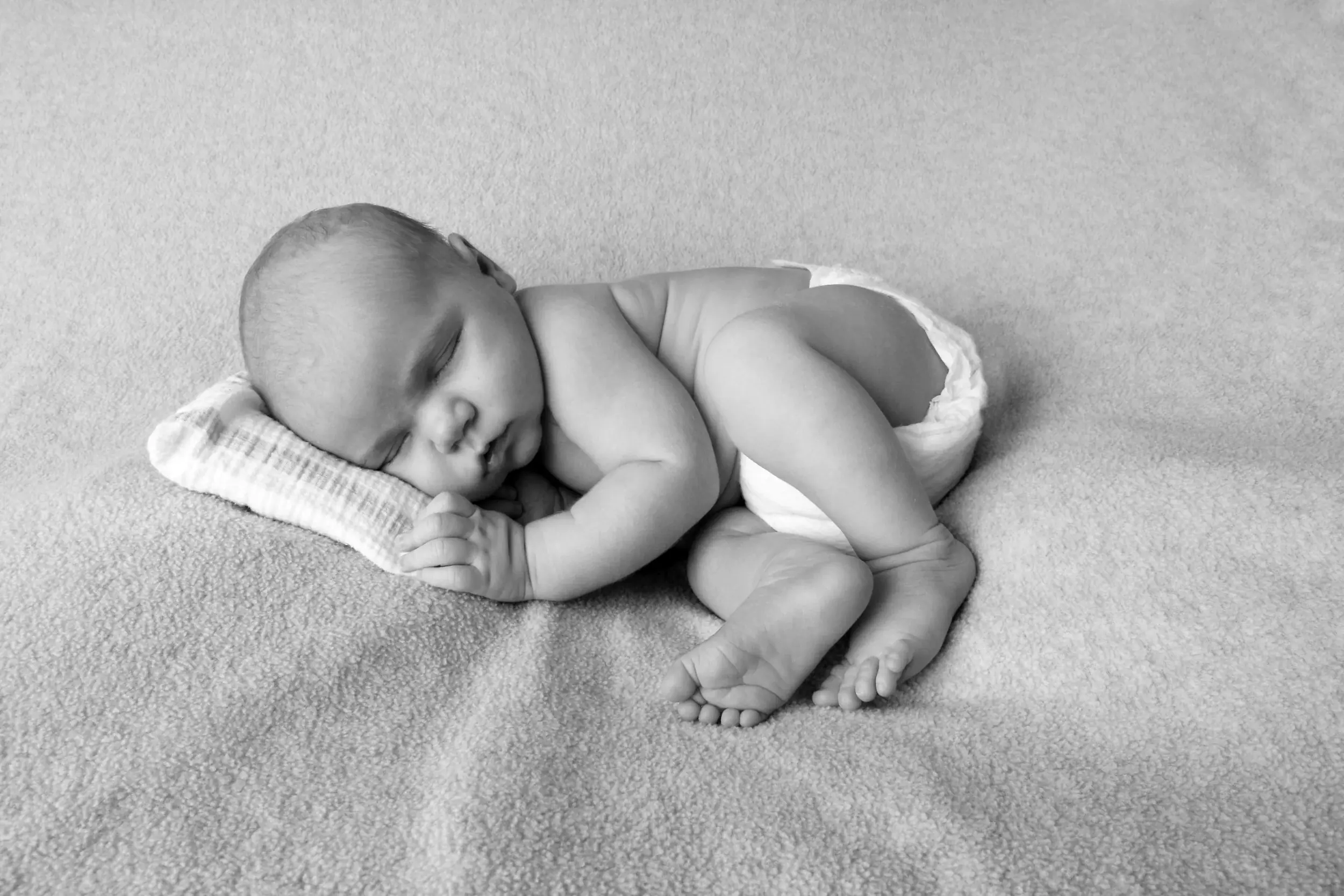 Sleeping newborn baby in a classic black-and-white portrait — Shannon's Newborn & Family Photography investment guide